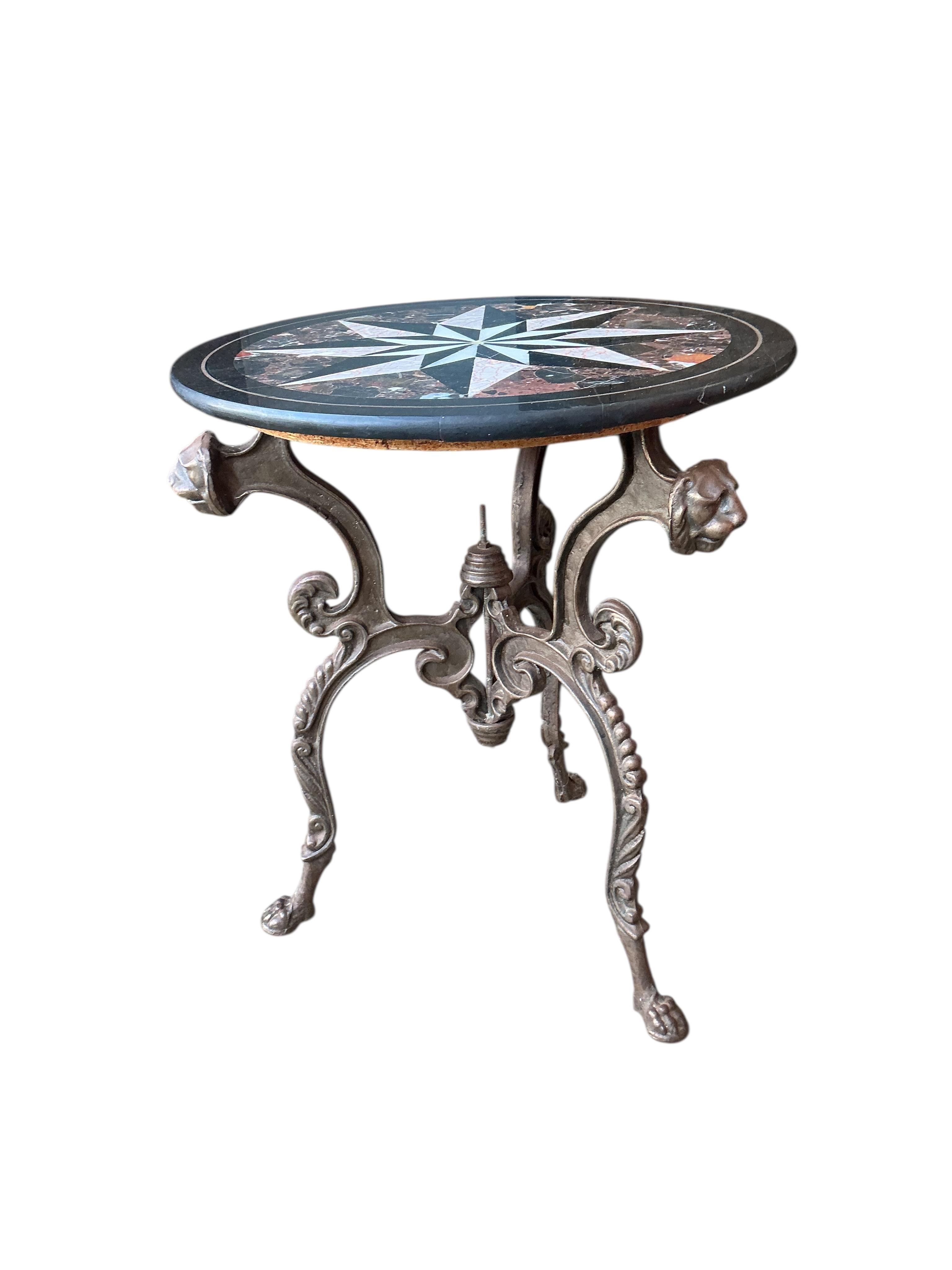 A circular specimen marble top occasional table on cast metal lion mask underframe, diameter 61cm, height 71cm